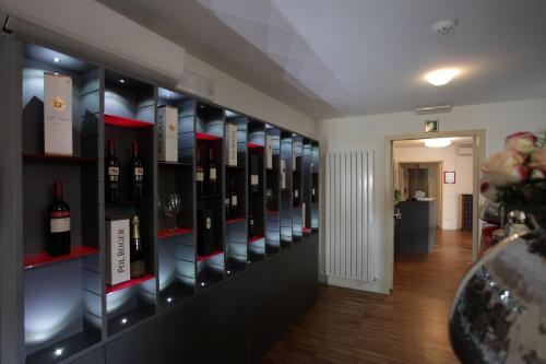a room with a bunch of bottles of wine on shelves at Albergo al Vecchio Tram in Udine