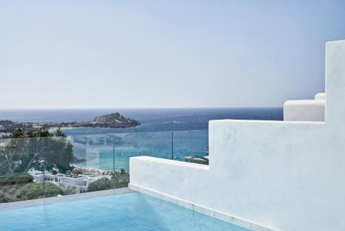 a swimming pool with a view of the ocean at Myconian Ambassador Relais & Chateaux in Platis Gialos