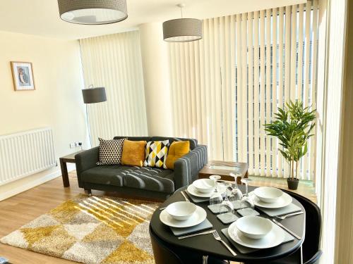a living room with a couch and a table at Smartrips Apartments - The Hub in Milton Keynes