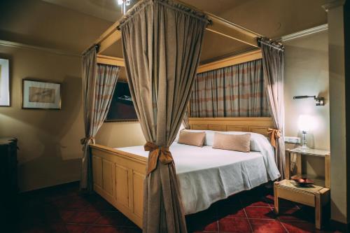 Säng eller sängar i ett rum på Hotel Carabeo