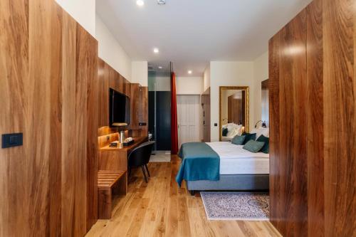 a hotel room with a bed and a desk at Boutique Hotel Dobrna - Terme Dobrna in Dobrna