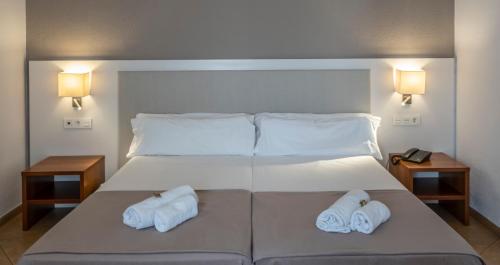 a hotel room with two beds and two lamps at Rosamar & Spa 4*s in Lloret de Mar