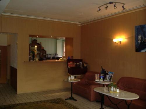 a living room with a couch and a table at GT Hotel in Dortmund