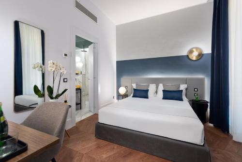 a bedroom with a large white bed and a desk at M20 Boutique Hotel in Milan