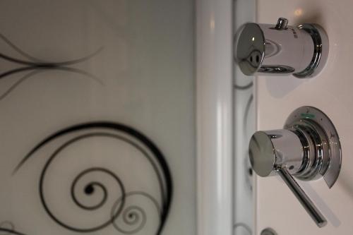 a close up of a door with a spiral on it at Albergo al Vecchio Tram in Udine