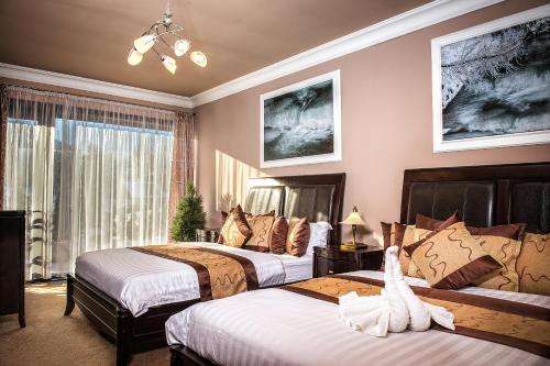 Ліжко або ліжка в номері Mountain Resort Residences