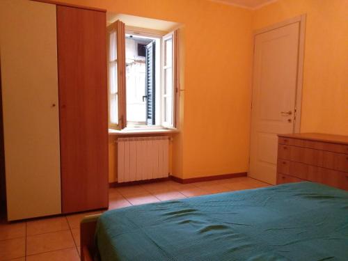 a bedroom with a bed and a window at Lovere Lake Apartment in Lovere