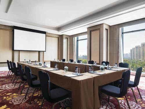 a conference room with a long table and chairs at The Langham, Hefei in Hefei