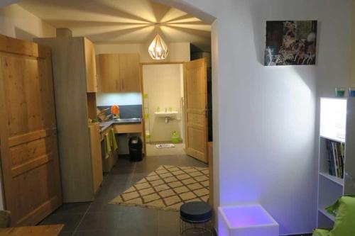 a kitchen with a hallway with a sink and a counter at Gîte le Rocher - Suitable for people with reduced mobility in La Grave