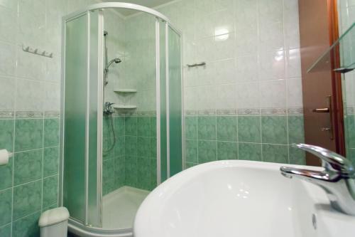 a bathroom with a shower and a white sink at Casa Luisa in Poreč
