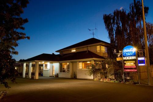 a house with a sign in front of it at Boundary Court Motor Inn in Hamilton