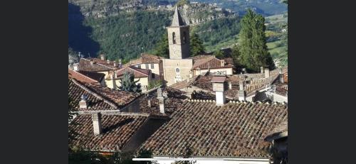 an aerial view of a village with a church and roofs at Casa del Dottore in Fano Adriano