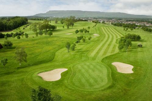 an overhead view of a green golf course with two eighteenth greens at Roe Valley Resort in Limavady