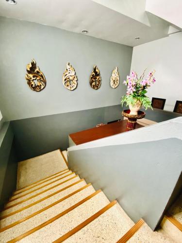 a room with stairs and plates on the wall at Phang Nga Guesthouse in Phangnga
