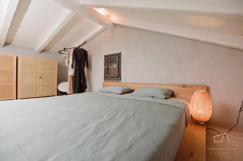 a bedroom with a large bed in a room at Heritage Stonehouse Jure in Krk