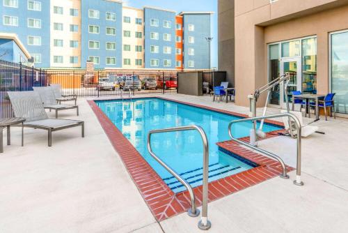 a swimming pool in a building with chairs and tables at La Quinta by Wyndham Oklahoma City Airport in Oklahoma City