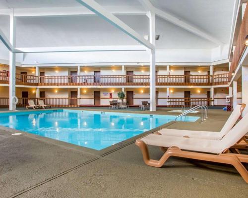 a large pool in a hotel with a lounge chair in front at Econo Lodge Inn & Suites in Stevens Point