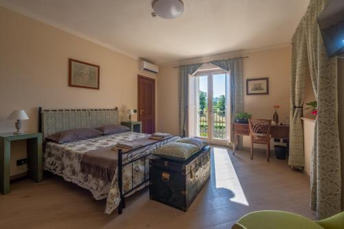 a bedroom with a bed and a large window at Il poggio degli antichi sapori in Paternopoli
