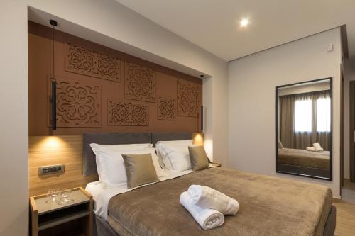 a bedroom with a large bed and a mirror at Giafra Luxury Rooms in Agrigento