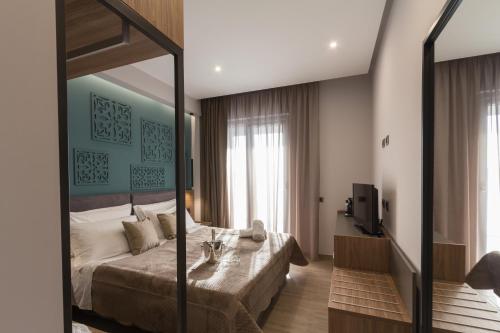 a bedroom with a bed and a table in it at Giafra Luxury Rooms in Agrigento