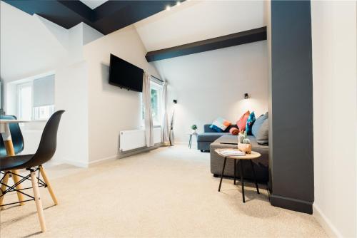 a living room with a couch and a table at Victoria Apartments Tamworth in Tamworth