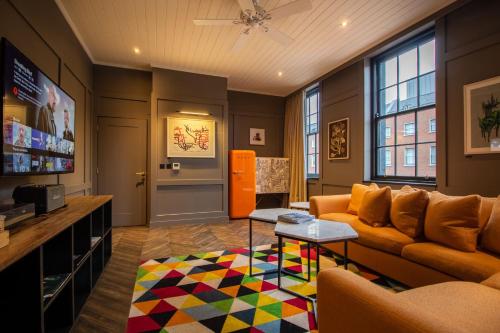 a living room with a couch and a colorful rug at The Dean Dublin in Dublin