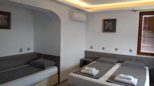 a bedroom with two beds and a window at Guest House Harmony in Veliko Tŭrnovo
