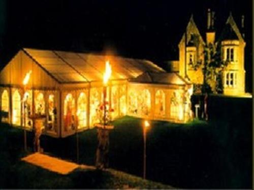 a large house with lights in front of it at night at Burcombe Manor in Barford Saint Martin