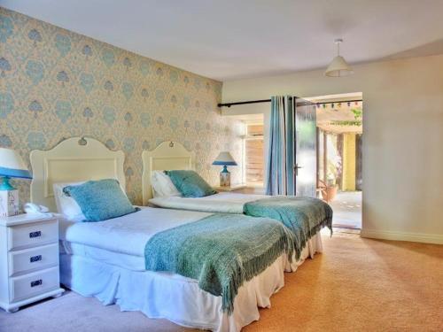 a bedroom with two beds and a window at Carrygerry Country House in Shannon