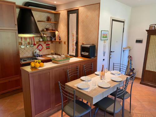 a kitchen with a table and chairs in a kitchen at St. Maurice smile in Ghiffa