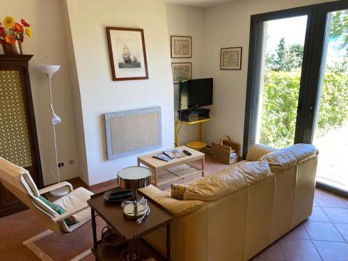 a living room with a couch and a tv at St. Maurice smile in Ghiffa