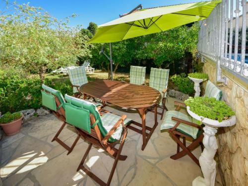 a patio with a table and chairs and an umbrella at Apartment Antoine by Interhome in Marina