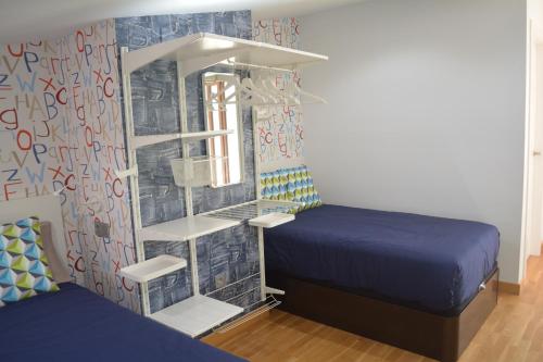 Postel nebo postele na pokoji v ubytování Apartamento Turístico Casa Museo Parking y Cargador