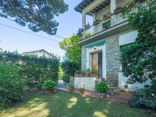 a house with a yard with potted plants at Holiday Home Madda by Interhome in Lido di Camaiore