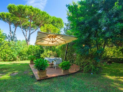 a patio with a table and an umbrella at Holiday Home Madda by Interhome in Lido di Camaiore