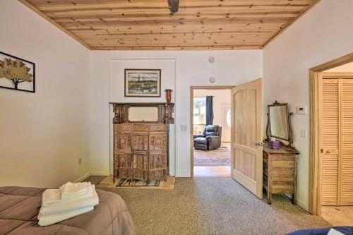 a bedroom with a bed and a tv and a couch at Secluded Camp Connell Home with Deck and Fireplace! in Camp Connell