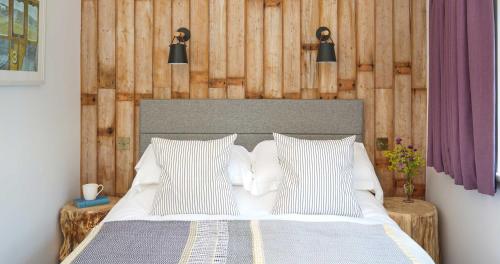 a bedroom with a bed with two white pillows at Bird & Carter Fonthill in Fonthill Bishop