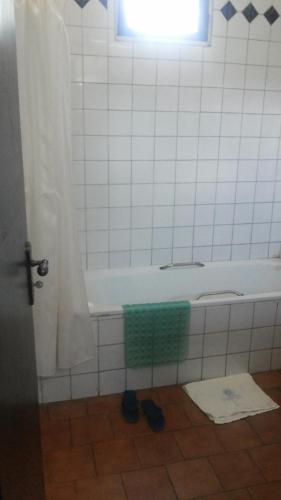 a bathroom with a bath tub with a window and a window at Sunset International Hotel in Jinja