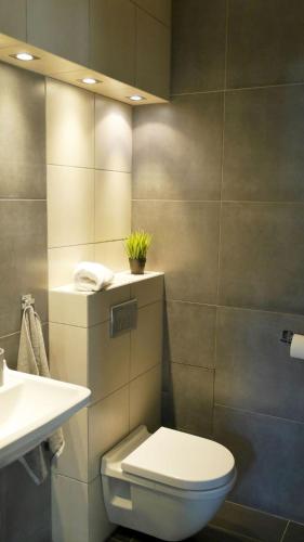 a bathroom with a toilet and a sink at JP Apartament Gdynia Centrum in Gdynia