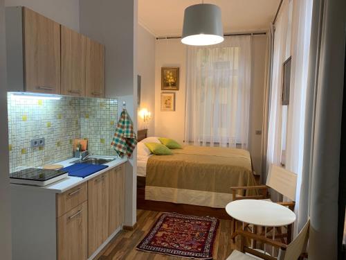 a small bedroom with a bed and a sink in it at NB Apartments Riga Old Town in Rīga
