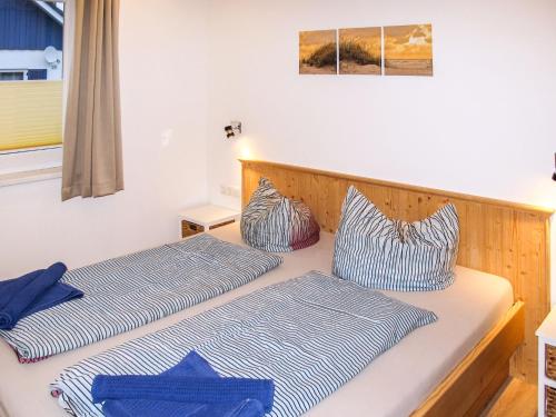 two beds sitting next to each other in a room at Holiday Home Heide by Interhome in Altefähr