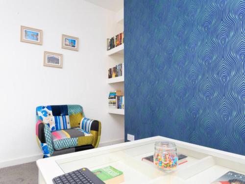 a room with a chair and a desk with a keyboard at Live in Leeds Grange Apartments in Leeds