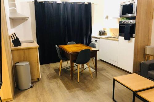 a small kitchen with a table and chairs in a room at Alta in Valloire