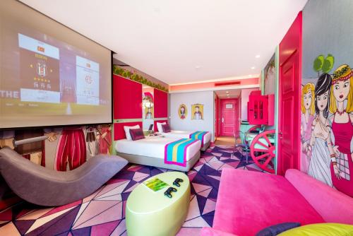 a room with a pink room with a bed and a tv at The Land Of Legends Kingdom Hotel - All-in Concept in Belek