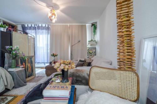 a living room with a couch and a table with books at Zurich Accomodation in Zurich