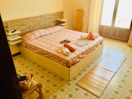 a bedroom with a large bed with a desk at La Terrazza Sul Mar Mediterraneo in Marinella di Selinunte