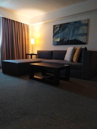 a living room with a couch and a coffee table at Hesperia Maracay in Maracay