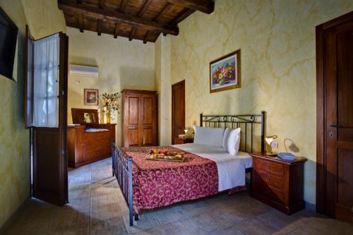 a bedroom with a bed with a tray of fruit on it at Villa Hotel Valle Del Marta Resort in Tarquinia