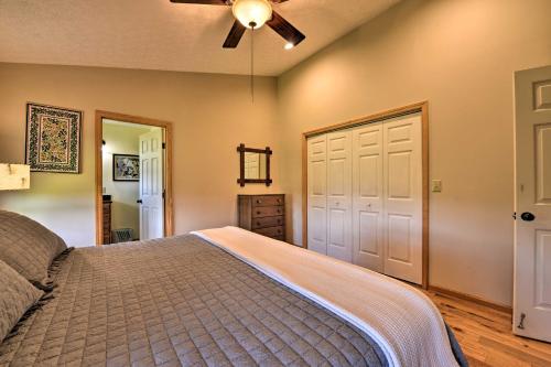 a bedroom with a bed and a ceiling fan at Charming Galax Retreat with Wraparound Deck! in Galax