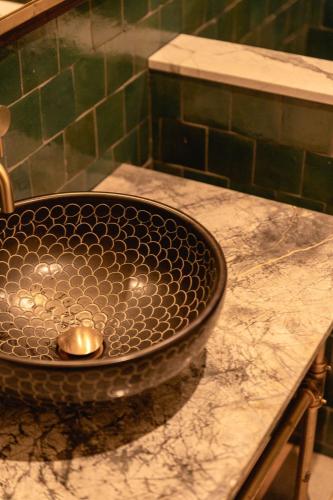 a bathroom sink with a metal sink at The Mayson in Dublin
